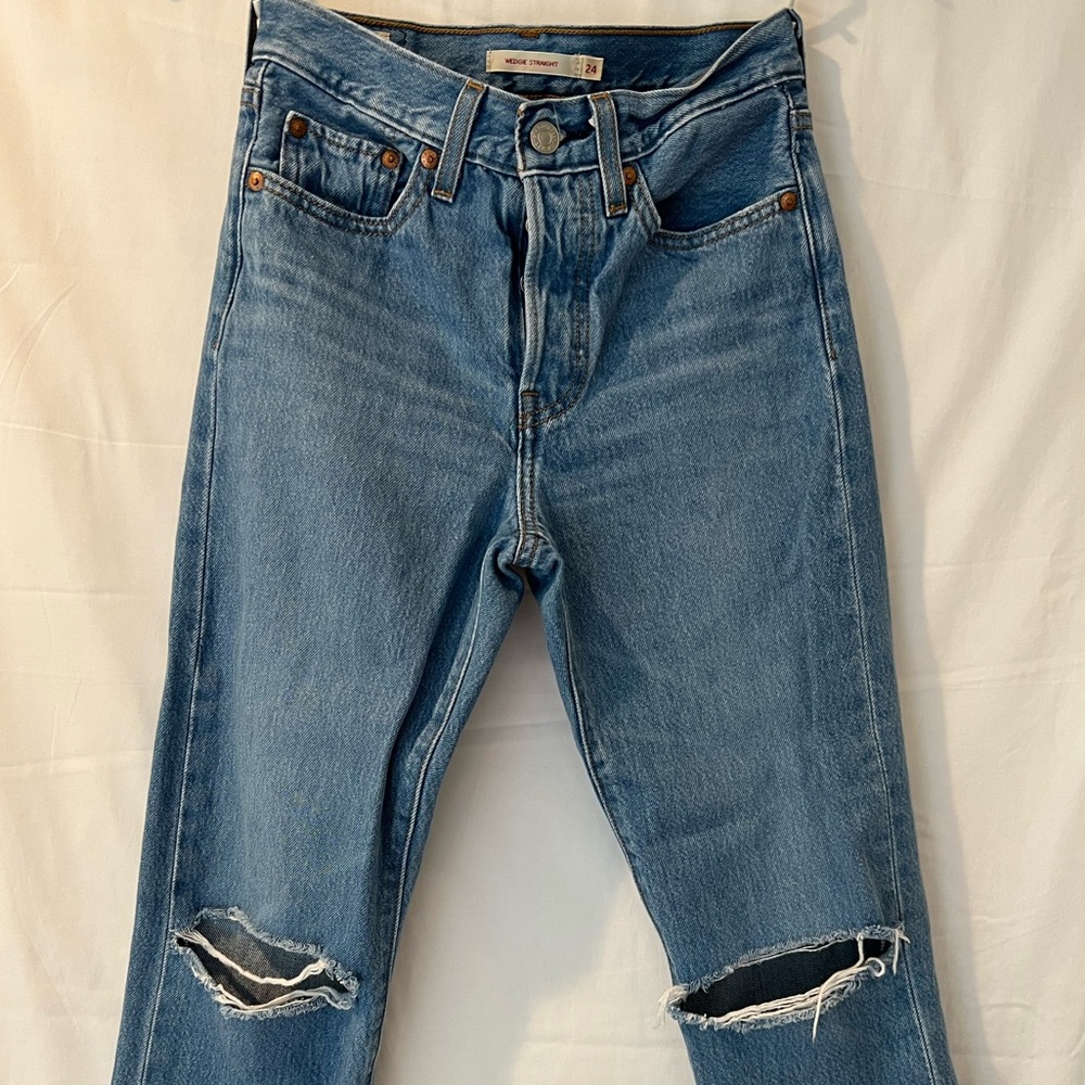 Tattered Levi’s wedgie fit relaxed leg denim jeans